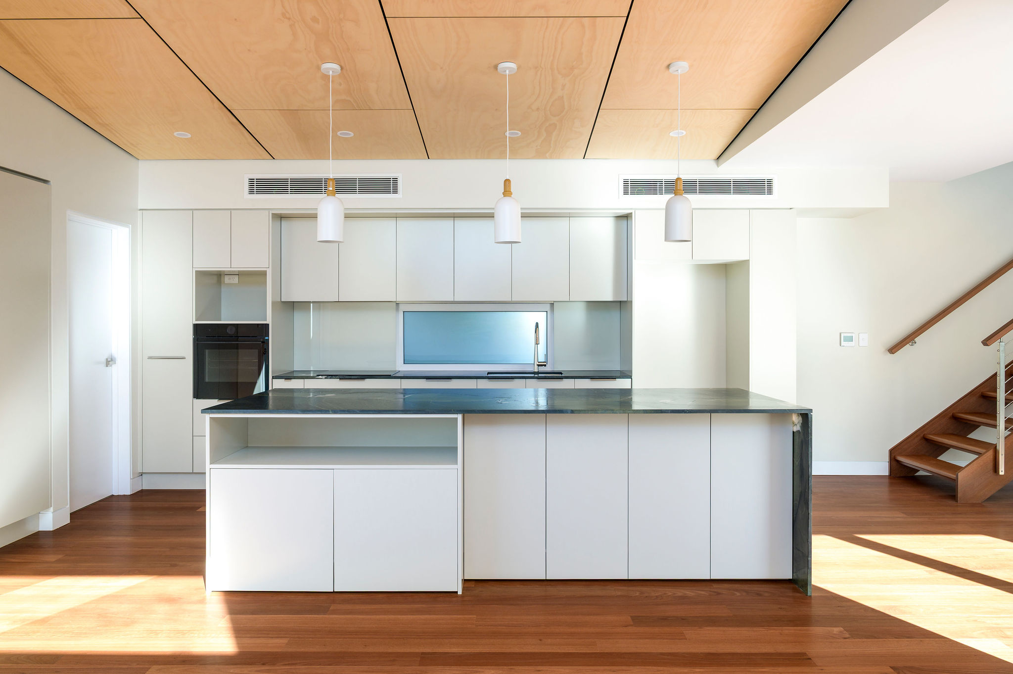 Stockton House kitchen and living area with timber ceiling and natural light
